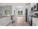 Bright kitchen featuring stainless steel appliances, modern white cabinets, and durable countertops at 12331 Fulmar Rd, Weeki Wachee, FL 34614