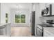 Open concept kitchen featuring stainless steel appliances and a view to the backyard at 12331 Fulmar Rd, Weeki Wachee, FL 34614