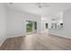 Bright living room featuring light wood floors, sliding glass doors, and an open floor plan at 12331 Fulmar Rd, Weeki Wachee, FL 34614