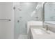 Modern tiled walk-in shower featuring glass doors, rainfall showerhead, and built-in shelving at 12331 Fulmar Rd, Weeki Wachee, FL 34614