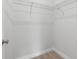 Walk-in closet with wire shelving and wood-look flooring at 12331 Fulmar Rd, Weeki Wachee, FL 34614