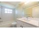 Bright bathroom featuring a shower-tub combo, and a modern vanity at 12709 Castleberry Ct, Hudson, FL 34667