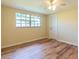 Bedroom featuring hardwood floors, a ceiling fan, and natural light at 12709 Castleberry Ct, Hudson, FL 34667