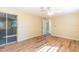 Bedroom with hardwood floors, closet, sliding door, and ceiling fan at 12709 Castleberry Ct, Hudson, FL 34667