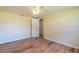 Bright bedroom featuring wood-look floors and a ceiling fan at 12709 Castleberry Ct, Hudson, FL 34667