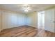 Bedroom with wood-look floors, closet, and doorway to a bathroom at 12709 Castleberry Ct, Hudson, FL 34667