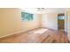 Bedroom with hardwood floors, a ceiling fan, and a bathroom at 12709 Castleberry Ct, Hudson, FL 34667