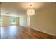 Large living room with hardwood floors, neutral paint, and lots of natural light at 12709 Castleberry Ct, Hudson, FL 34667