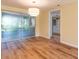 Open-concept living room featuring modern lighting fixture and glass sliding door at 12709 Castleberry Ct, Hudson, FL 34667