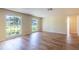 Bright and airy living room with laminated floors and large windows at 12709 Castleberry Ct, Hudson, FL 34667