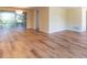 Spacious living room featuring new hardwood floors and a sliding glass door at 12709 Castleberry Ct, Hudson, FL 34667