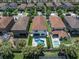 Expansive aerial view of backyard oasis featuring a unique pool, putting green, and lush landscaping at 12889 Burns Dr, Odessa, FL 33556