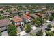 Aerial view of a residential neighborhood featuring well-maintained homes with terracotta tile roofs and mature trees at 12889 Burns Dr, Odessa, FL 33556
