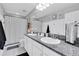 Bright bathroom features granite counters, dual sinks, and tiled floors at 12889 Burns Dr, Odessa, FL 33556