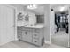 Clean bathroom with dual sinks, framed mirror, and a walk-in closet at 12889 Burns Dr, Odessa, FL 33556