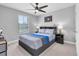 Comfortable bedroom with a modern ceiling fan and natural light at 12889 Burns Dr, Odessa, FL 33556
