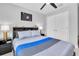 Bedroom with ceiling fan, dark bedside tables, and a baseball theme at 12889 Burns Dr, Odessa, FL 33556