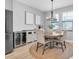 Cozy dining area with modern furnishings, a chandelier, and a stainless steel wine cooler at 12889 Burns Dr, Odessa, FL 33556
