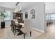 Elegant dining room with contemporary lighting, hardwood floors, and seating for six at 12889 Burns Dr, Odessa, FL 33556