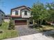 Charming two-story home with a tile roof, dark wood garage, and manicured lawn at 12889 Burns Dr, Odessa, FL 33556
