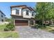 Charming home with a stone facade, lush landscaping, and a spacious driveway at 12889 Burns Dr, Odessa, FL 33556
