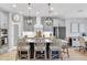 Elegant kitchen with an island, quartz counters, stainless steel appliances, and modern light fixtures at 12889 Burns Dr, Odessa, FL 33556