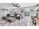 Comfortable living area with a large sectional, area rug, and dedicated workspace at 12889 Burns Dr, Odessa, FL 33556