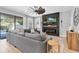 Spacious living room with a large sectional sofa, fireplace, and entertainment center at 12889 Burns Dr, Odessa, FL 33556