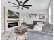 Cozy living room featuring a modern fireplace, sectional seating, and shiplap accent wall at 12889 Burns Dr, Odessa, FL 33556