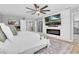 Serene main bedroom showcasing a decorative fireplace, accent wall, and a ceiling fan at 12889 Burns Dr, Odessa, FL 33556