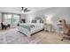 Spacious main bedroom with a king bed, neutral decor, wood floors and a ceiling fan at 12889 Burns Dr, Odessa, FL 33556