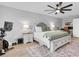 Comfortable main bedroom featuring a ceiling fan, and a desk with natural light at 12889 Burns Dr, Odessa, FL 33556