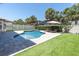 Private pool with lush landscaping, lounge chairs, and a sunny patio area at 12889 Burns Dr, Odessa, FL 33556