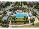 Aerial view of a pool and amenity center, equipped with lounging and playground area at 12889 Burns Dr, Odessa, FL 33556