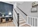 Stylish staircase with white risers, wooden handrail, and accent wall with modern decor at 12889 Burns Dr, Odessa, FL 33556