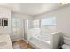 Bathroom features soaking tub, walk-in shower and double sinks creating a luxurious and functional space at 13098 Hanley Dr, Spring Hill, FL 34609