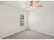 Bedroom with carpet, ceiling fan, and window allowing natural light in to create a peaceful retreat at 13098 Hanley Dr, Spring Hill, FL 34609