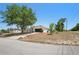 Angle view of a single-story home with a driveway, lawn, and mature tree, highlighting its curb appeal at 13098 Hanley Dr, Spring Hill, FL 34609