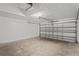 Spacious two car garage with a white door and concrete floors at 13098 Hanley Dr, Spring Hill, FL 34609
