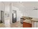 Modern kitchen with granite countertops, stainless steel appliances, and tile flooring, open to living spaces at 13098 Hanley Dr, Spring Hill, FL 34609