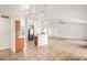 Spacious open-concept layout with tile floors, a kitchen island, and a seamless flow between living spaces at 13098 Hanley Dr, Spring Hill, FL 34609