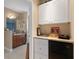Bathroom featuring vanity, mirror, toilet, and a utility area with mini-fridge at 13810 Celida Ave, Hudson, FL 34667