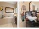 Bathroom featuring a soaking tub and tiled floors at 13810 Celida Ave, Hudson, FL 34667