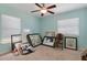 Bedroom with ceiling fan, window with blinds, and clutter on the floor at 13810 Celida Ave, Hudson, FL 34667