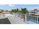 Wooden deck with white railings and lovely view of neighborhood canals and docks at 13810 Celida Ave, Hudson, FL 34667