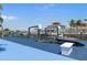 Waterfront home with a private boat lift, offering easy access to boating and water activities at 13810 Celida Ave, Hudson, FL 34667