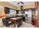 Kitchen with wooden cabinetry, tile floors, stainless steel appliances, and central island for meal prep at 13810 Celida Ave, Hudson, FL 34667
