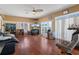 Spacious living room with hardwood floors, large windows, and a ceiling fan at 13810 Celida Ave, Hudson, FL 34667