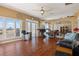 Inviting living room features hardwood floors, large windows, and an open layout to other rooms at 13810 Celida Ave, Hudson, FL 34667