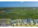 Aerial view of home backing to Florida preserve, nestled in gated community with nearby lake at 16557 Acoustic Loop, Land O Lakes, FL 34638